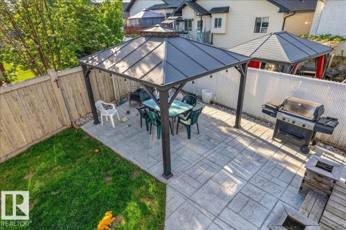 Expansive backyard featuring a stamped concrete patio, a covered gazebo, and a manicured lawn - 6050 164A Avenue, Edmonton, AB - Outdoor With Deck Patio Veranda