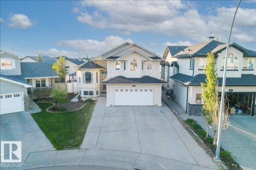 Residential exterior featuring a two-story design with light-colored siding and dark shingle roofing - 6050 164A Avenue, Edmonton, AB - Outdoor With Facade