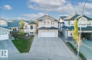 Residential exterior featuring a two-story design with light-colored siding and dark shingle roofing - 6050 164A Avenue, Edmonton, AB  - Outdoor With Facade 