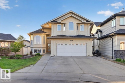 Stucco-finished exterior with a two-car garage and concrete driveway - 6050 164A Avenue, Edmonton, AB - Outdoor With Facade