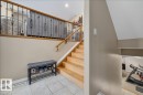 Split-level entry with light wood stairs and a wrought iron and wood banister - 6050 164A Avenue, Edmonton, AB  - Indoor Photo Showing Other Room 