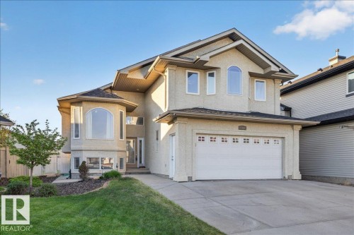 Exterior facade with stucco finish, a double garage with decorative windows, and a prominent bay window feature - 6050 164A Avenue, Edmonton, AB - Outdoor With Facade