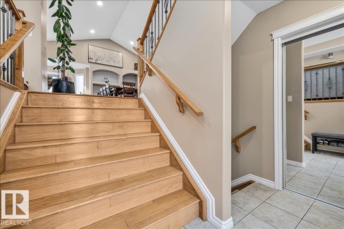 Hardwood staircase with wrought iron balusters and wood handrails - 6050 164A Avenue, Edmonton, AB - Indoor Photo Showing Other Room
