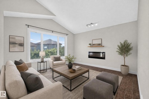 Spacious living area featuring a vaulted ceiling and wood-finish flooring - 1346 Cunningham Drive, Edmonton, AB 