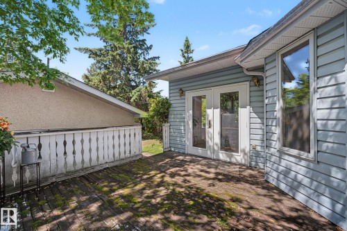 Wood-finish deck with a white spindle railing - 9516 146 Street, Edmonton, AB 