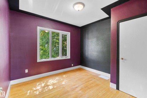 Hardwood-style flooring with natural light from a multi-pane window - 10607 73 Ave, Edmonton, AB 