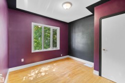 Hardwood-style flooring with natural light from a multi-pane window - 