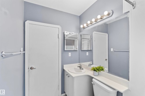Bathroom vanity with an integrated sink and white cabinetry - 10607 73 Ave, Edmonton, AB 