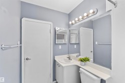 Bathroom vanity with an integrated sink and white cabinetry - 