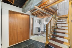 Staircase featuring wood risers and handrail, leading to an exterior door - 