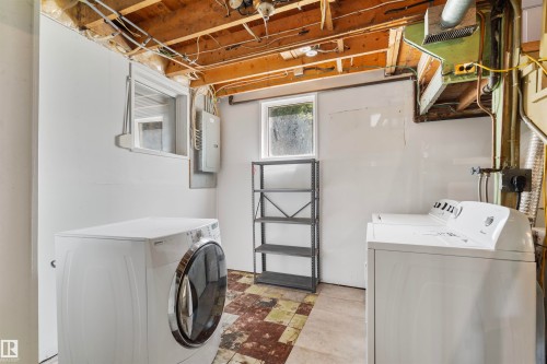 Utility space featuring exposed ceiling joists, white paneled walls, and a window - 10607 73 Ave, Edmonton, AB 