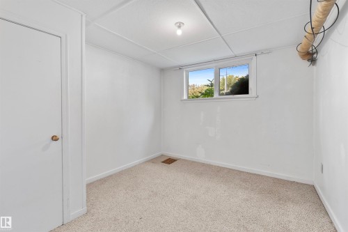Carpeted room with white walls, a white ceiling, and a single window - 10607 73 Ave, Edmonton, AB 