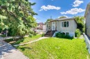 Stucco exterior residence with a front lawn and established trees - 10607 73 Ave, Edmonton, AB 