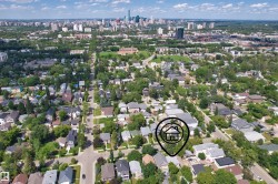 Aerial perspective of a residential neighborhood with a distant cityscape - 
