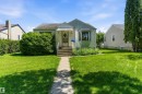 Single-story residence featuring light-colored siding and a bay window - 11619 123 Street, Edmonton, AB 
