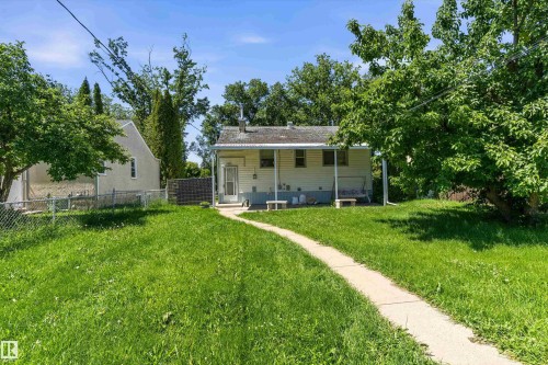 Single-story residence featuring a covered front porch and a light-colored exterior - 11619 123 Street, Edmonton, AB 