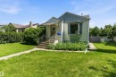 Siding exterior with a bay window, concrete steps, and a wrought iron railing - 11619 123 Street, Edmonton, AB 