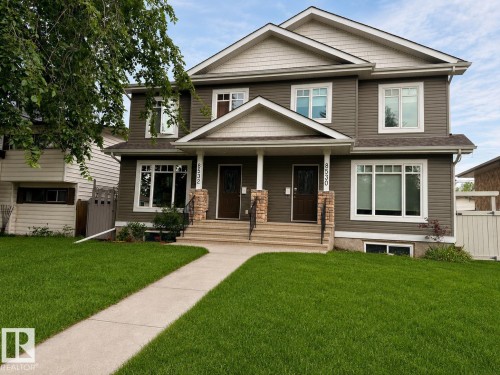 Duplex property featuring a neutral-toned siding facade with light trim accents - Front Lawn was rendered - 8530 76 Avenue, Edmonton, AB 