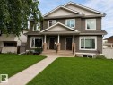 Duplex property featuring a neutral-toned siding facade with light trim accents - Front Lawn was rendered - 8530 76 Avenue, Edmonton, AB 