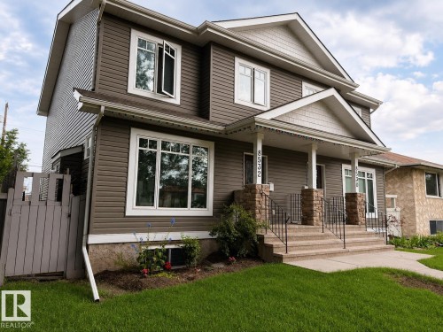 Two-story residence featuring horizontal siding and white trim - Front lawn was rendered - 8530 76 Avenue, Edmonton, AB 