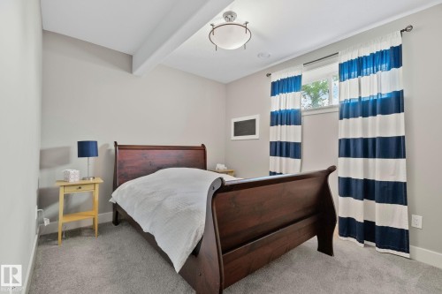 Carpeted room featuring a window with natural light, light gray wall paint, white trim, and a flush mount ceiling light fixture - 9 Greenfield Wynd, Fort Saskatchewan, AB - Indoor Photo Showing Bedroom