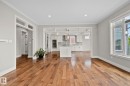 Open-concept living area featuring wood-finish flooring, recessed lighting, and a white trim package - 9 Greenfield Wynd, Fort Saskatchewan, AB  - Indoor Photo Showing Kitchen 