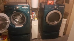 Front-loading washer and dryer set, each with integrated pedestal drawers, providing efficient laundry capabilities - 