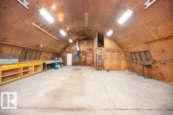 Spacious vaulted interior with concrete flooring - 
