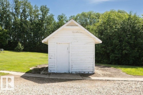 White gable-roofed shed with a single entry door - 25023 Twp Rd 612, Rural Westlock County, AB 