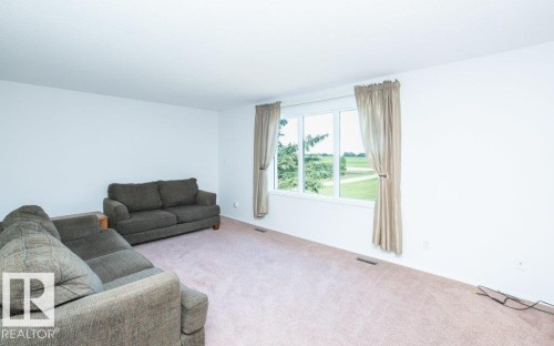 Bright room featuring light-toned carpeting and white walls - 25023 Twp Rd 612, Rural Westlock County, AB 