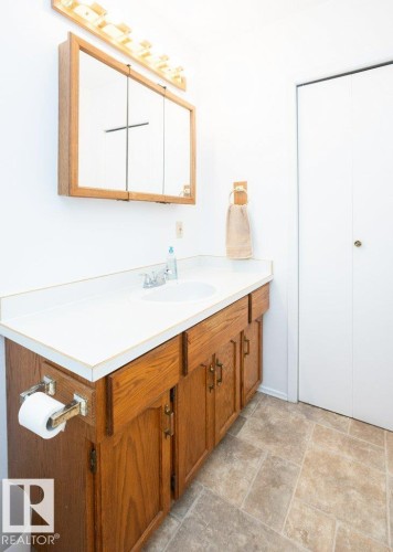 Bathroom vanity featuring a white countertop and integrated sink - 25023 Twp Rd 612, Rural Westlock County, AB 