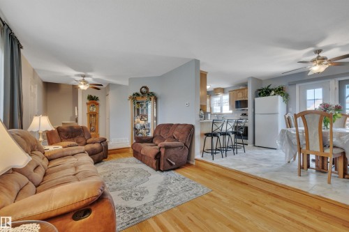 Living area featuring wood-finish flooring, a ceiling fan, and recessed wall paneling - 184 Garwood Cres, Wetaskiwin, AB - Indoor Photo Showing Living Room