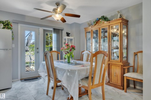 Dining area featuring light-toned tile flooring, a ceiling fan with integrated lighting, and a double patio door with internal grids - 184 Garwood Cres, Wetaskiwin, AB - Indoor Photo Showing Dining Room