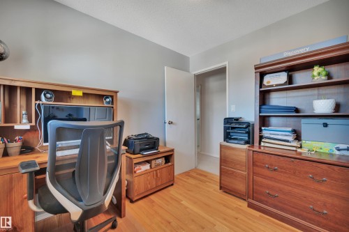 Hardwood-style flooring throughout this room, featuring light gray wall paint and a white ceiling - 184 Garwood Cres, Wetaskiwin, AB - Indoor