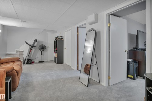Spacious carpeted area with neutral wall tones - 184 Garwood Cres, Wetaskiwin, AB - Indoor