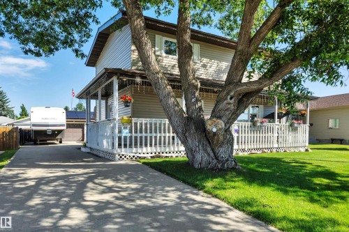 Two-story residence featuring light-toned siding and a covered front porch with white railings - 184 Garwood Cres, Wetaskiwin, AB - Outdoor With Deck Patio Veranda