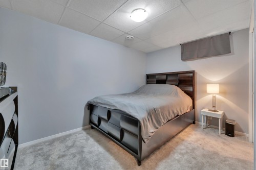 Spacious room featuring light gray walls, plush gray carpeting, and a drop ceiling with recessed lighting - 184 Garwood Cres, Wetaskiwin, AB - Indoor Photo Showing Bedroom