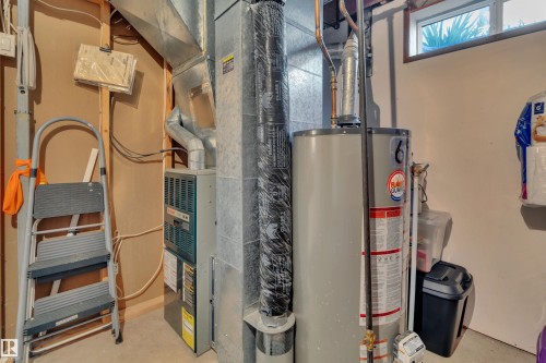 Mechanical room featuring a water heater, furnace, and exposed ductwork - 184 Garwood Cres, Wetaskiwin, AB - Indoor Photo Showing Basement