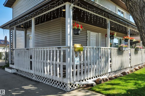 Exterior featuring a covered porch with white wooden railings and lattice skirting - 184 Garwood Cres, Wetaskiwin, AB - Outdoor With Deck Patio Veranda
