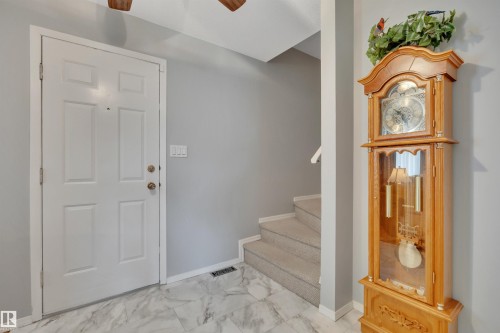 Foyer featuring a white paneled entry door, light gray wall paint, and marble-look tile flooring - 184 Garwood Cres, Wetaskiwin, AB - Indoor Photo Showing Other Room