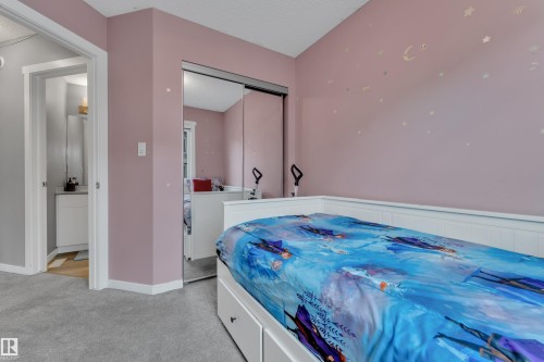 Room featuring light pink walls and gray carpet flooring - 82 1816 Rutherford Road, Edmonton, AB 