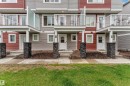 Multi-level townhome exterior featuring red and gray siding - 82 1816 Rutherford Road, Edmonton, AB 