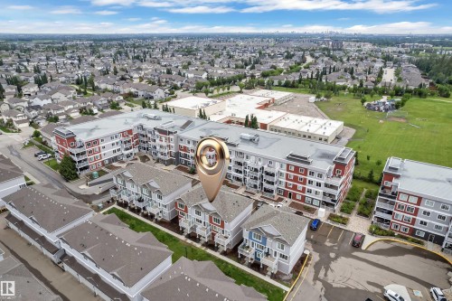 Aerial overview of a residential area featuring multi-story buildings with contrasting facades - 82 1816 Rutherford Road, Edmonton, AB 