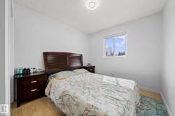 Bright room featuring light-toned walls and wood-finish flooring - 