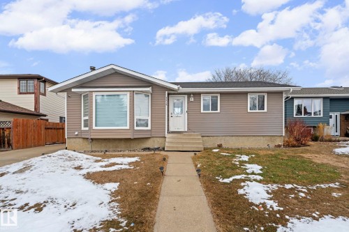Ranch-style residence featuring neutral-toned horizontal siding and a prominent bay window - 5418 17A Avenue, Edmonton, AB 