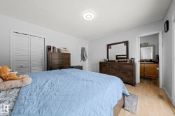 Bedroom featuring light wood-finish flooring and a ceiling-mounted light fixture - 
