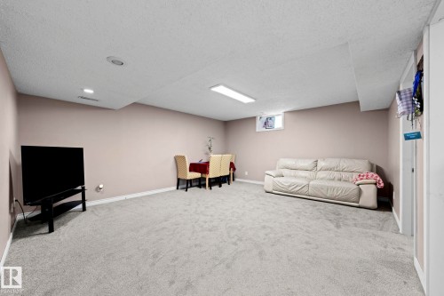 Spacious lower level featuring light gray carpeting, neutral wall tones, and recessed lighting - 5418 17A Avenue, Edmonton, AB 