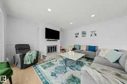 Living area with recessed lighting, crown molding, and wainscoting - 
