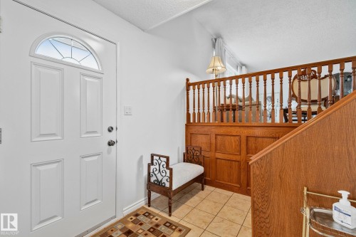 Entryway featuring a white paneled door with an arched transom window - 10715 33 Avenue, Edmonton, AB 