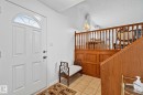 Entryway featuring a white paneled door with an arched transom window - 10715 33 Avenue, Edmonton, AB 